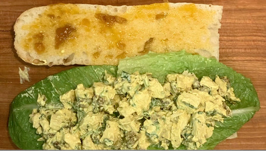 Wurzpott Gourmet Spices Smoky Curry Saffron Chicken Salad Sandwich on a sub roll with spice jars 